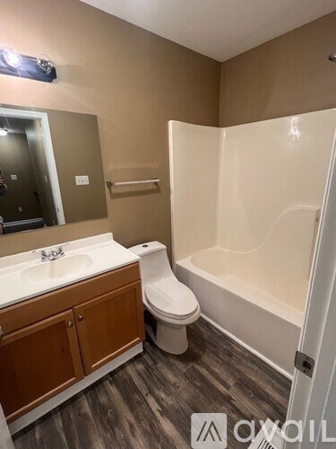 A bathroom with a white sink, toilet, and bathtub.