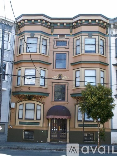 A brown building with a tree in front of it.