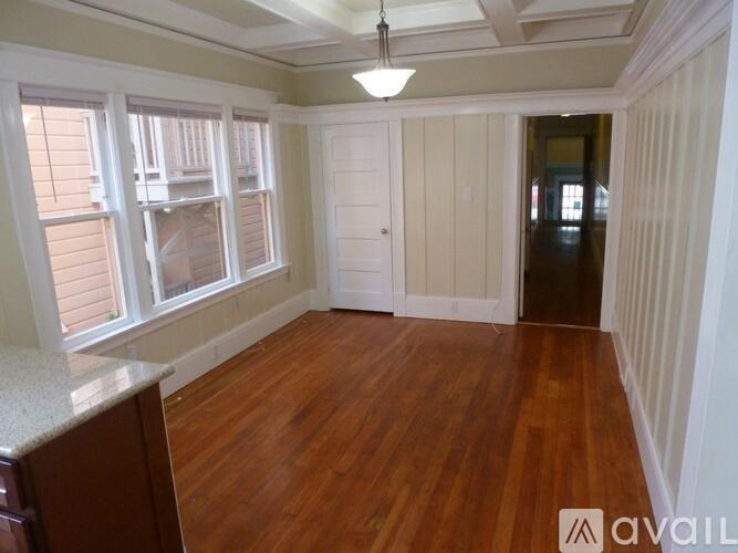 A room with wooden floors and a kitchen island.