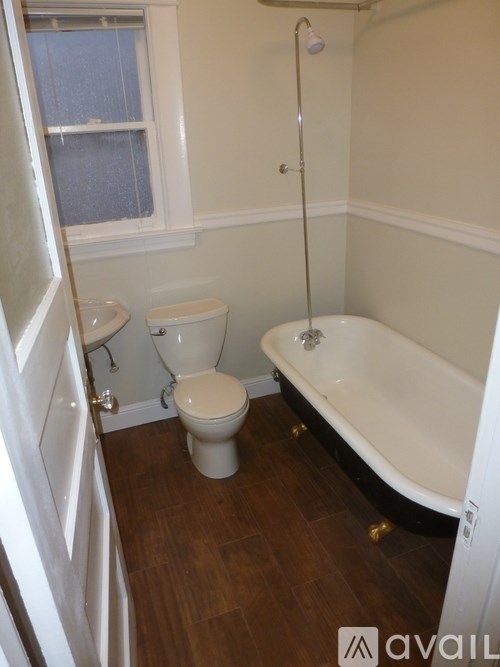 A white toilet and sink in a small bathroom.