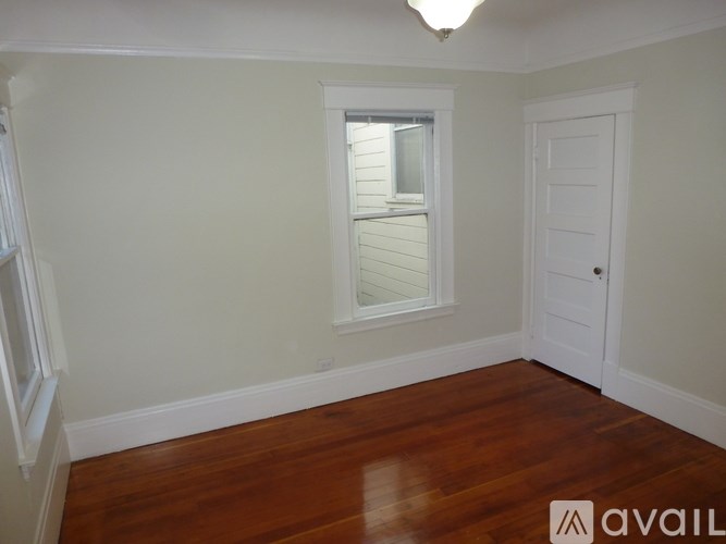 A room with wooden floors and white walls.