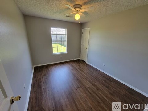 A room with a ceiling fan and a window.