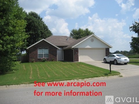 A house with a car parked in front and a sign that says "See www.arcapio.com for more information".