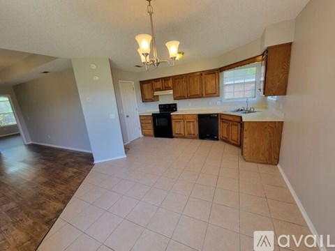 A kitchen with wooden cabinets and black appliances.