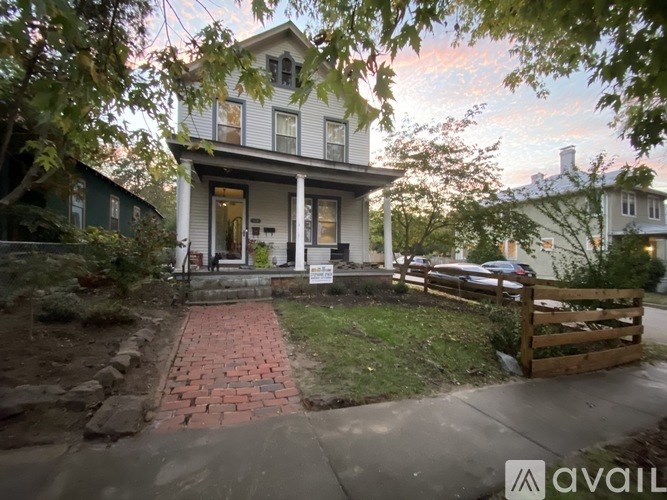 A house with a porch and a sign that says "available" in front of it.