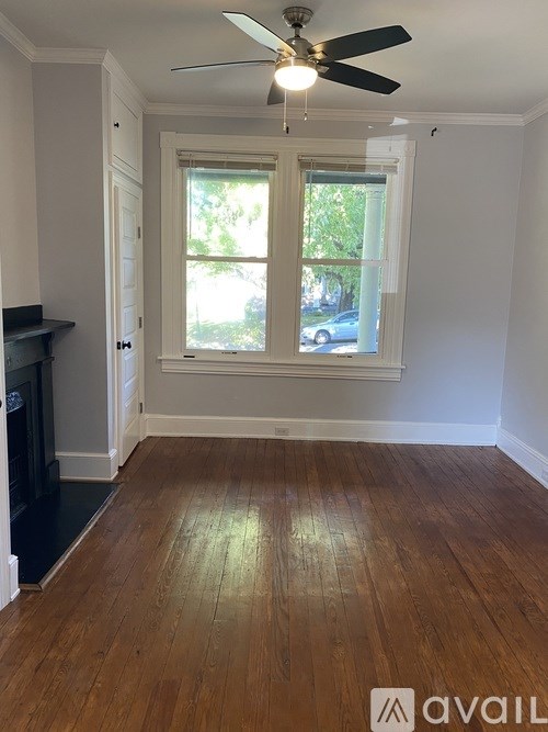 A room with a ceiling fan and a window.