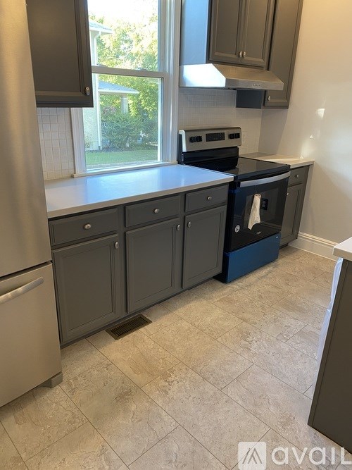 A kitchen with a stove, oven, and refrigerator.