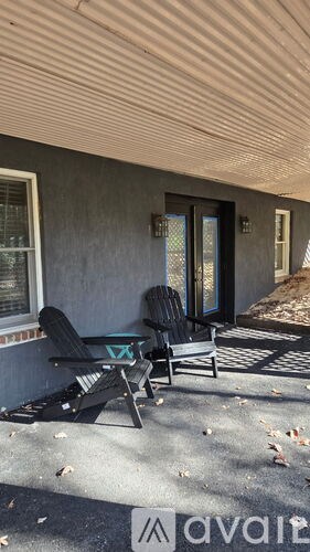 A patio with a chair and a table.