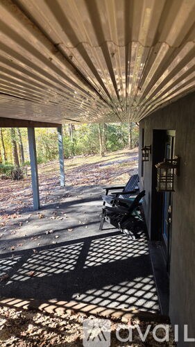 A covered walkway with a black and white checkered floor.