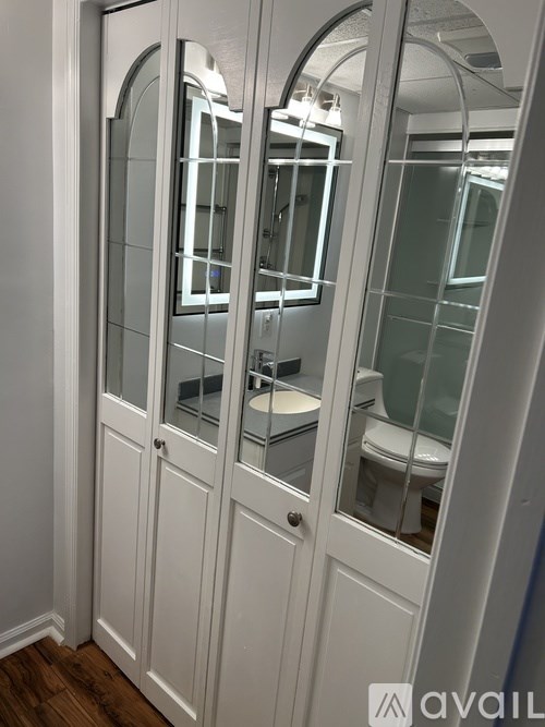 A white bathroom with a toilet and sink.