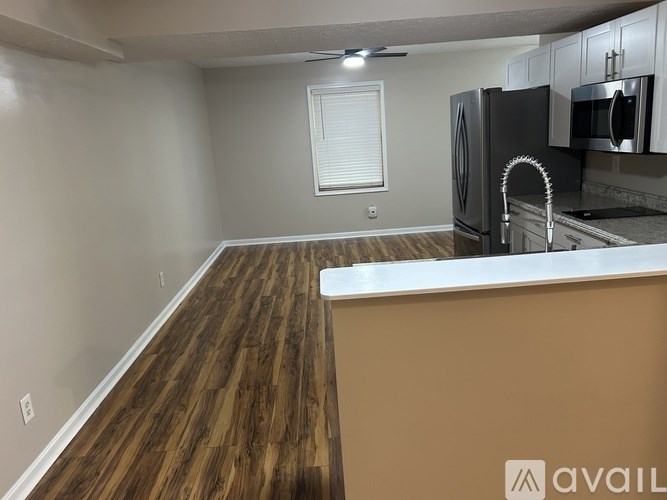 A kitchen with a wooden floor and a counter.