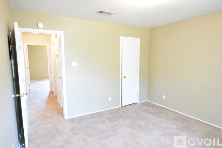A room with a white door and a black door.