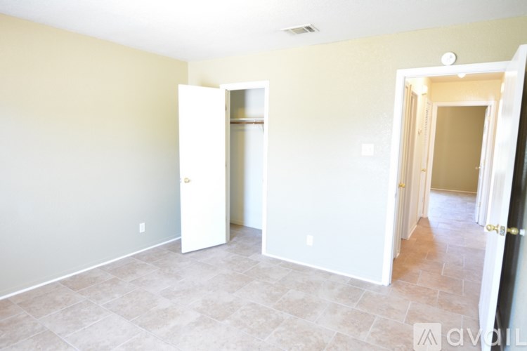 A room with a tile floor and two open doors.