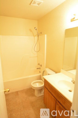 A bathroom with a toilet, sink, and bathtub.