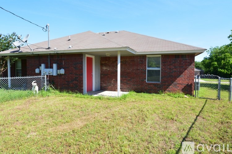 A house with a red door and a dog in front.