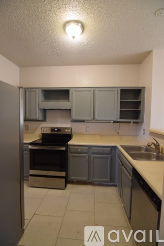 A kitchen with a stove, oven, and sink.