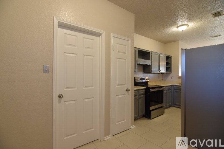 A kitchen area with two doors and a counter.