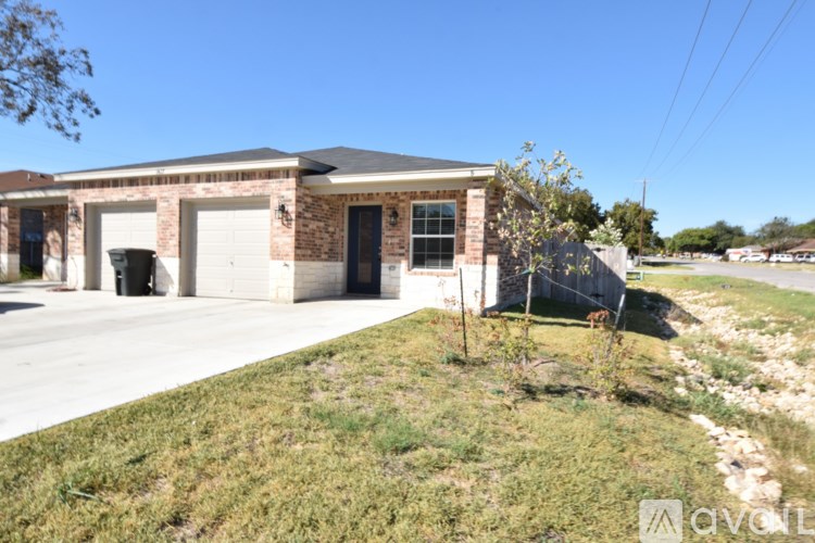 A two-story house with a garage and a driveway.