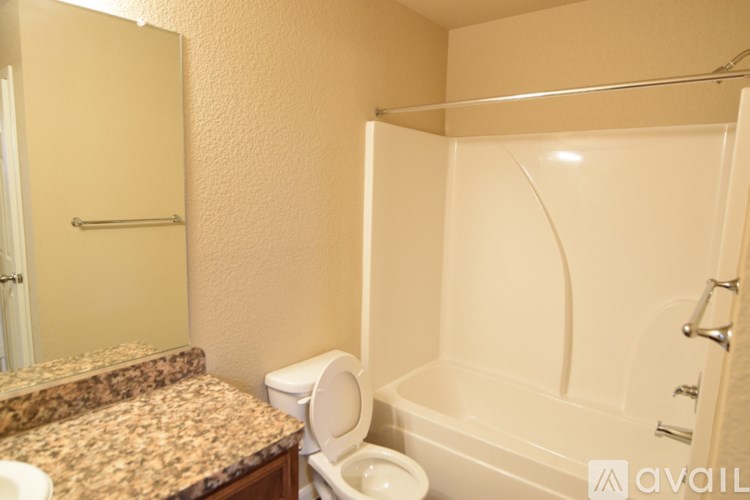 A bathroom with a toilet, sink, and bathtub.