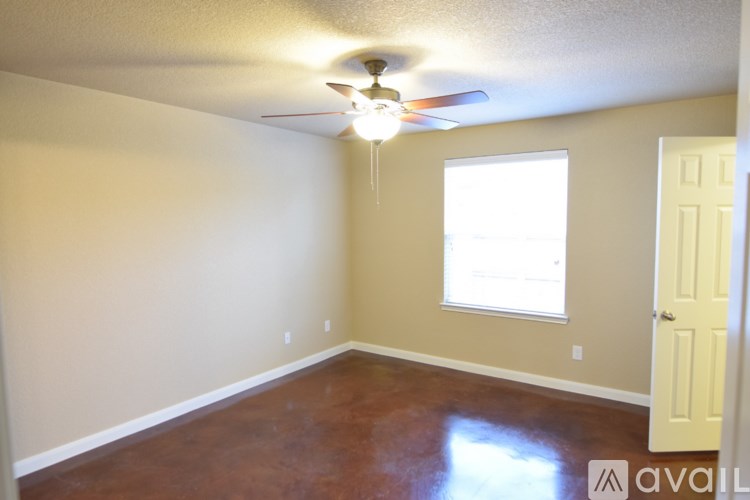A room with a ceiling fan and a window.