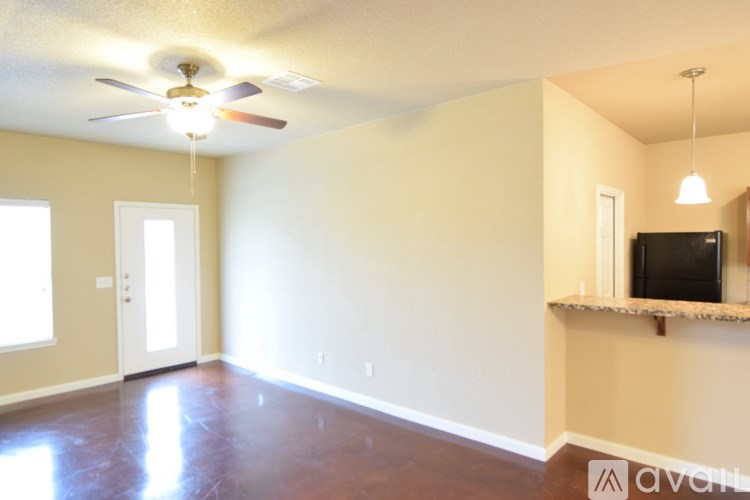 A living room with a television and a ceiling fan.