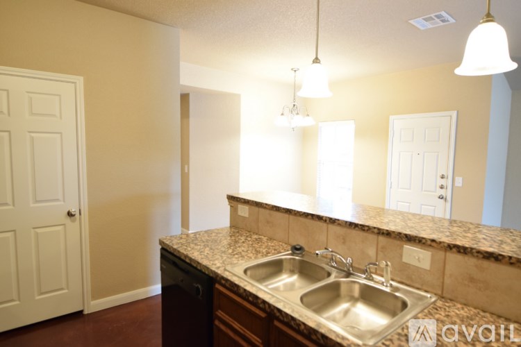 A kitchen with a sink and a counter.