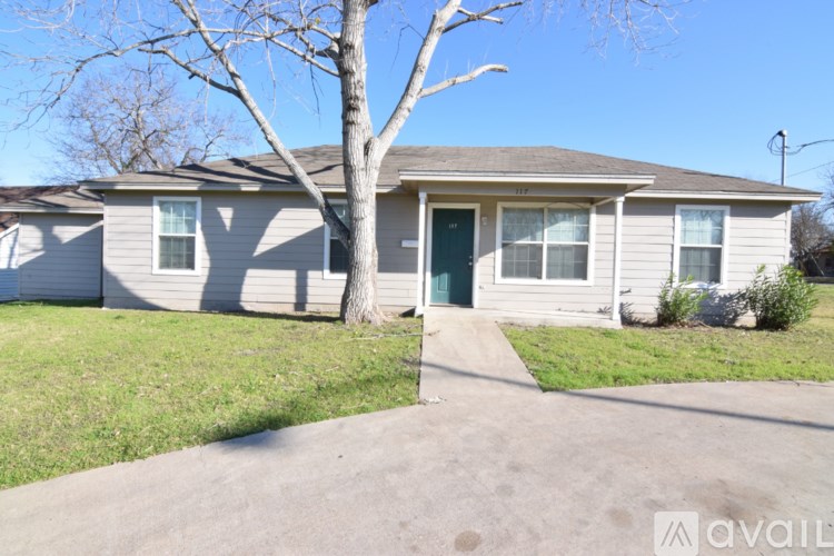 A house with a tree in front of it.