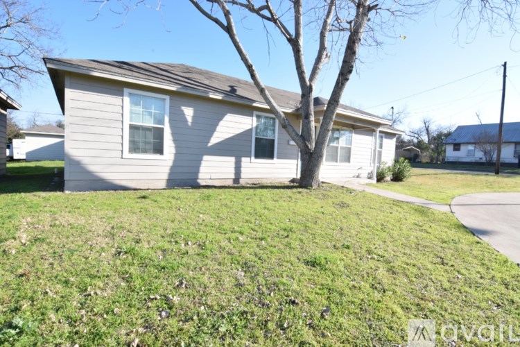A house with a tree in front of it.