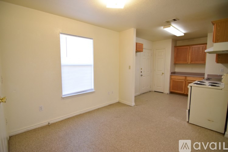A room with a window and a white appliance.