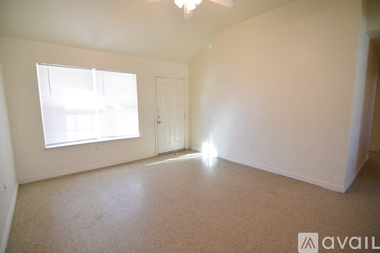 A room with a window and a door is available for rent.