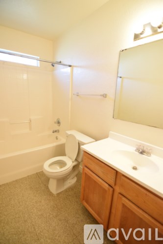 A bathroom with a toilet, sink, and bathtub.
