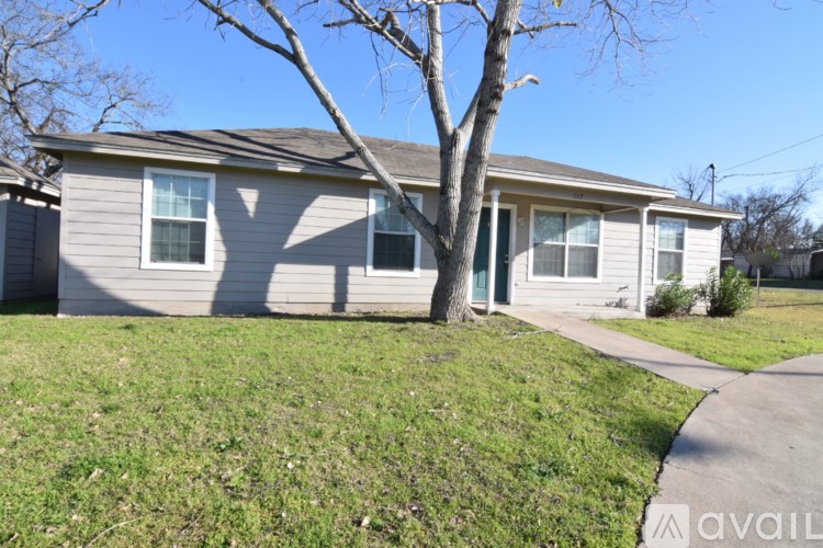 A house with a tree in front of it.