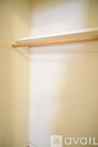 A wooden shelf is mounted on a wall.