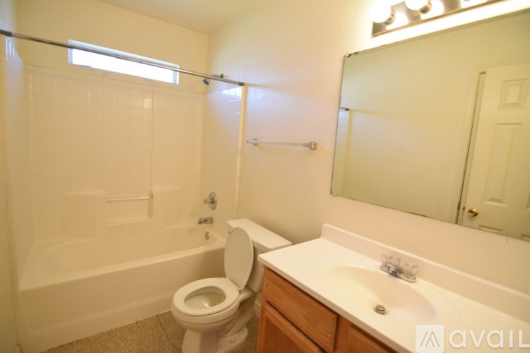 A bathroom with a toilet, sink, and bathtub.
