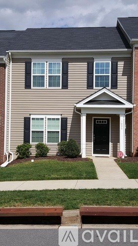 A house with a front yard and a driveway.
