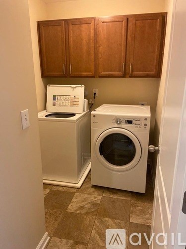 A small laundry room with a washer and dryer.