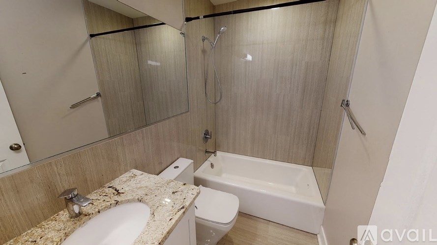 A bathroom with a sink, toilet, and bathtub.