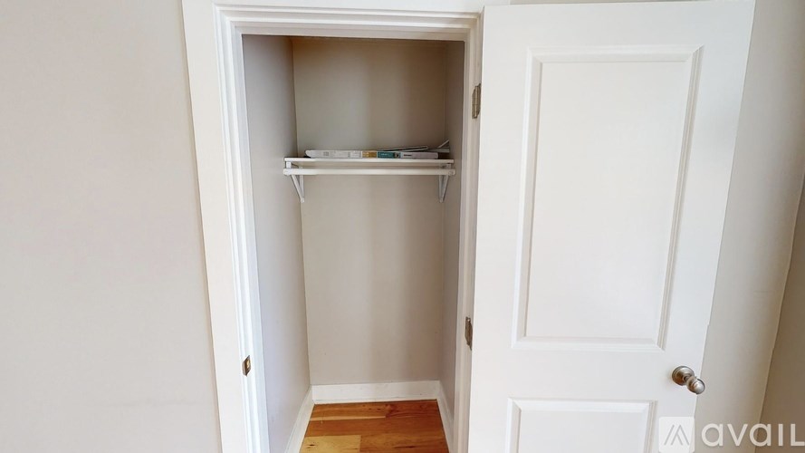 A white door with a shelf inside it.