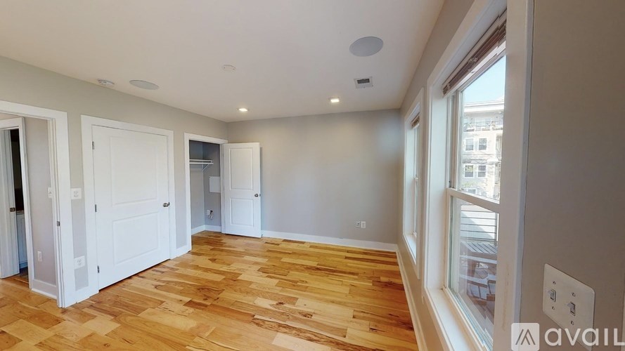 A room with wooden flooring and white walls is available for rent.