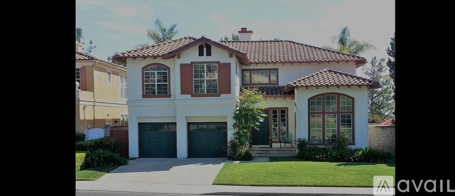 A house with a red tile roof and a garage door.