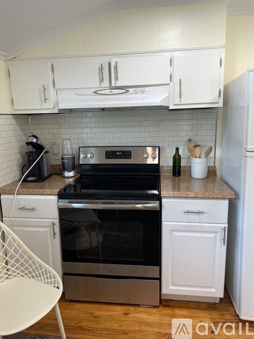 A kitchen with a stove, oven, and refrigerator.