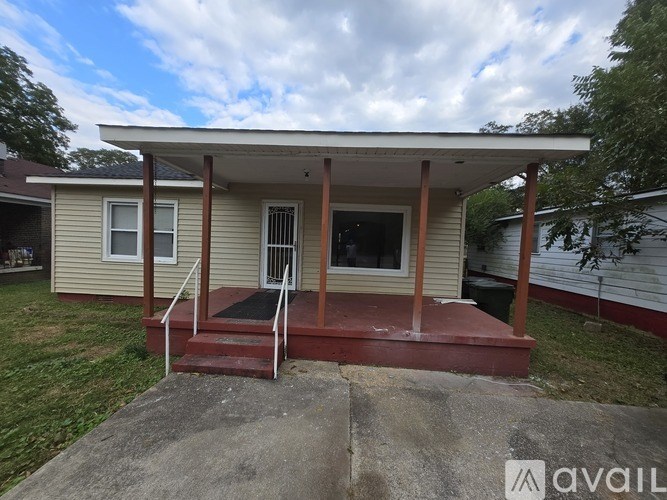 A small house with a porch and a covered entrance.