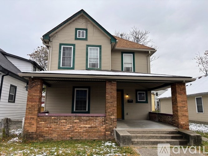 A house with a porch and a front yard.