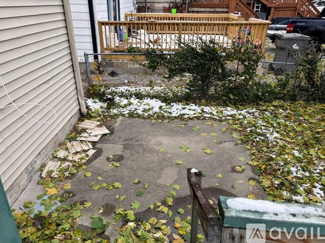 A small garden area with a wooden deck and a bench.