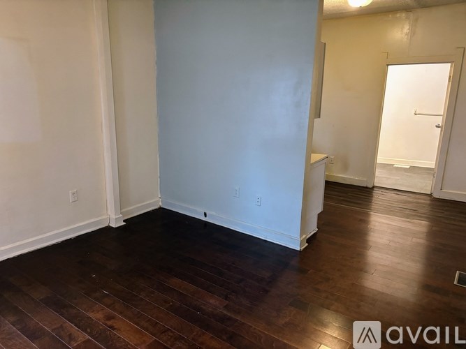 A room with wooden floors and white walls.