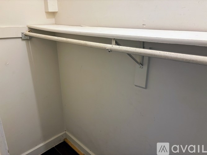 A white shelf is mounted on a wall.