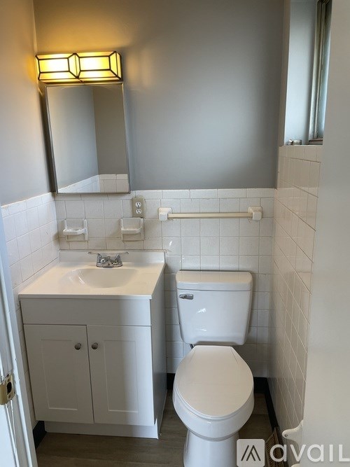 A white toilet sits next to a sink in a bathroom.