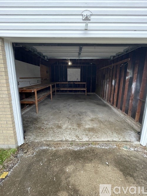 A garage with a table and bench inside.