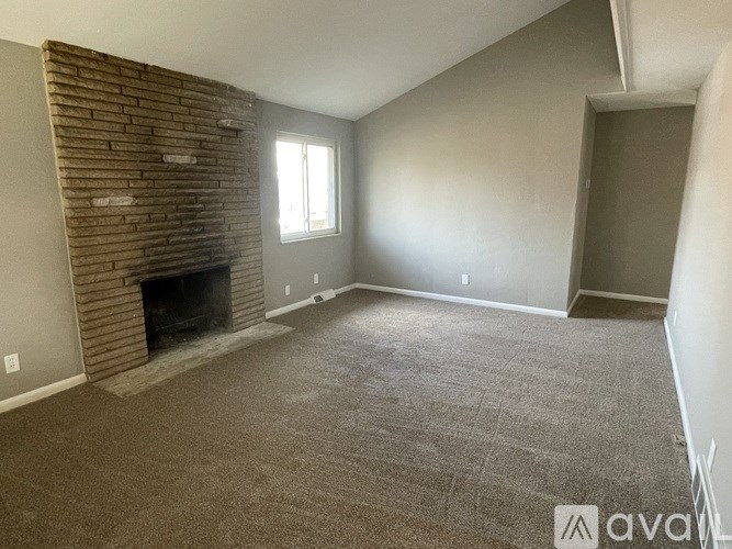 A room with a fireplace and a window.