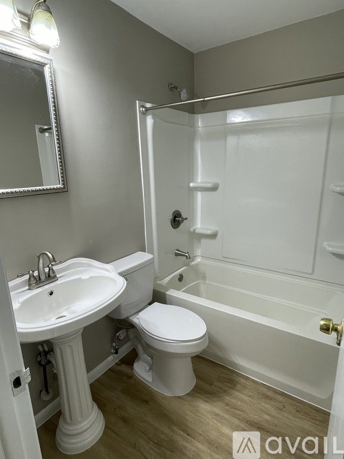 A bathroom with a sink, toilet and bathtub.